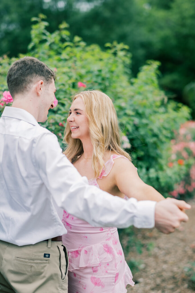 couple smiling and holding hands engagement session