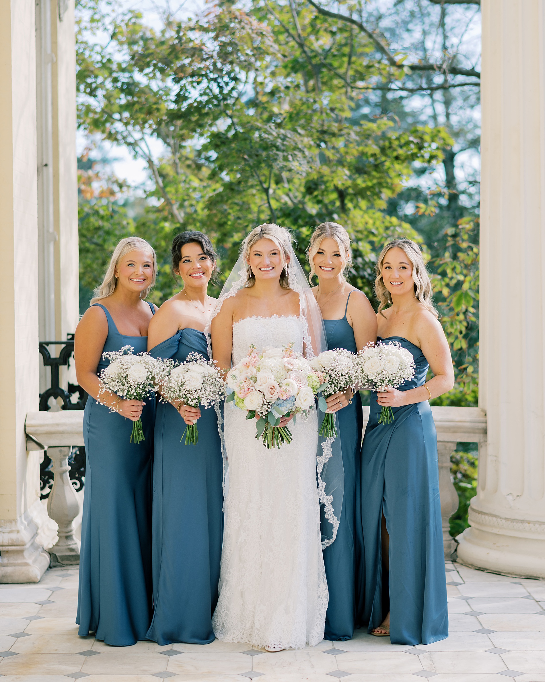 bride and bridesmaids in steel blue dresses