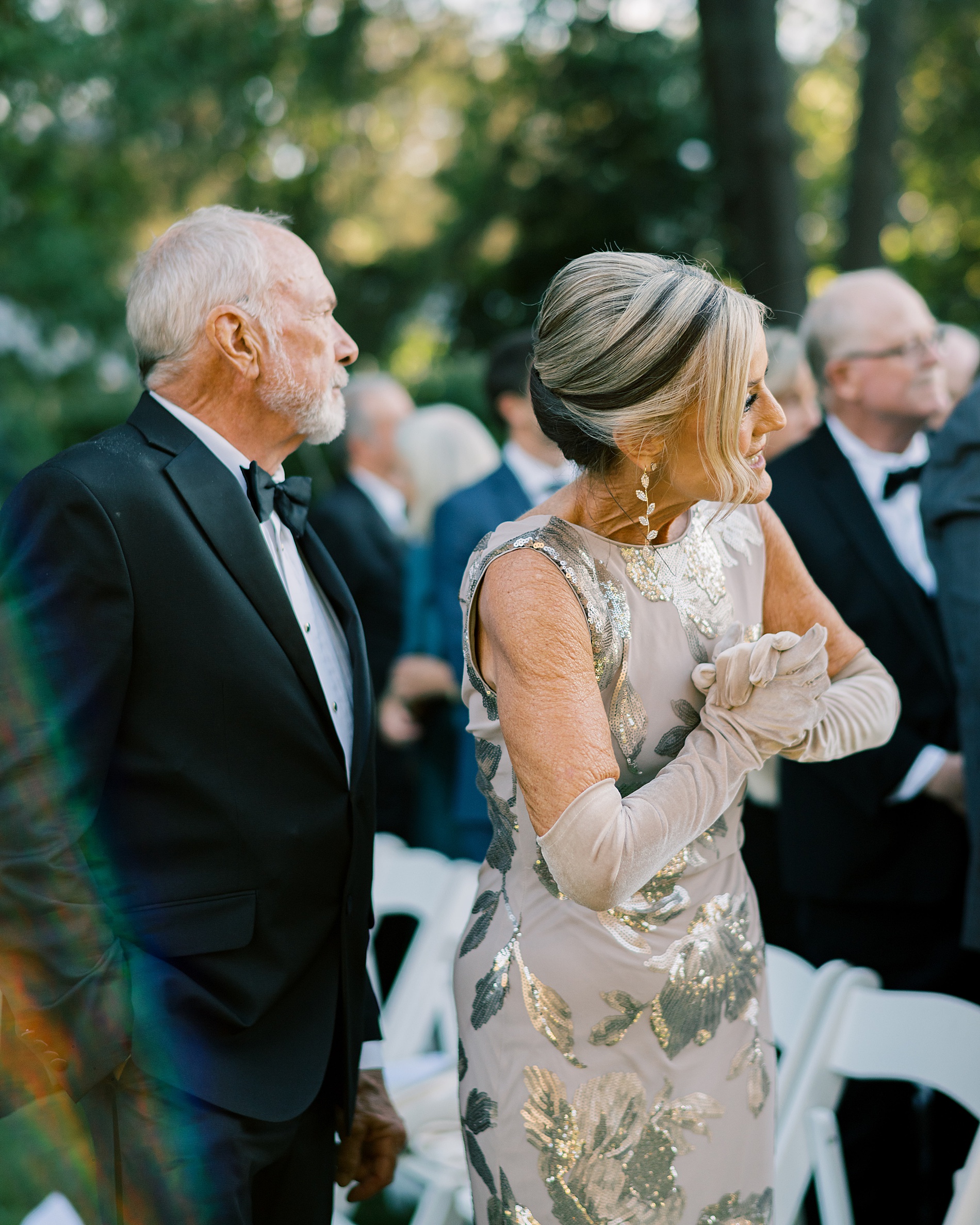 mother of the groom watches bride walk down the aisle  