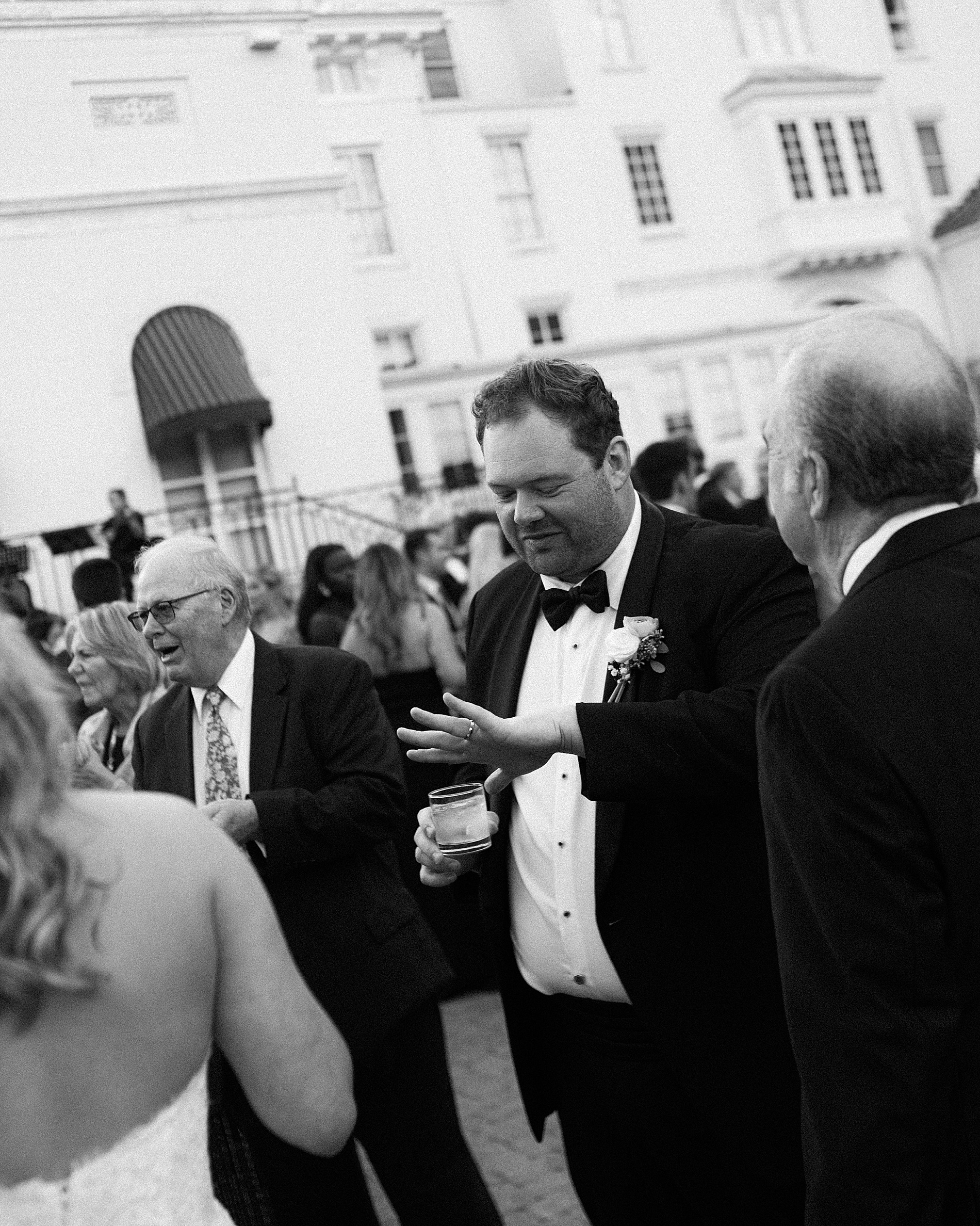 candid portrait of groom looking at wedding ring