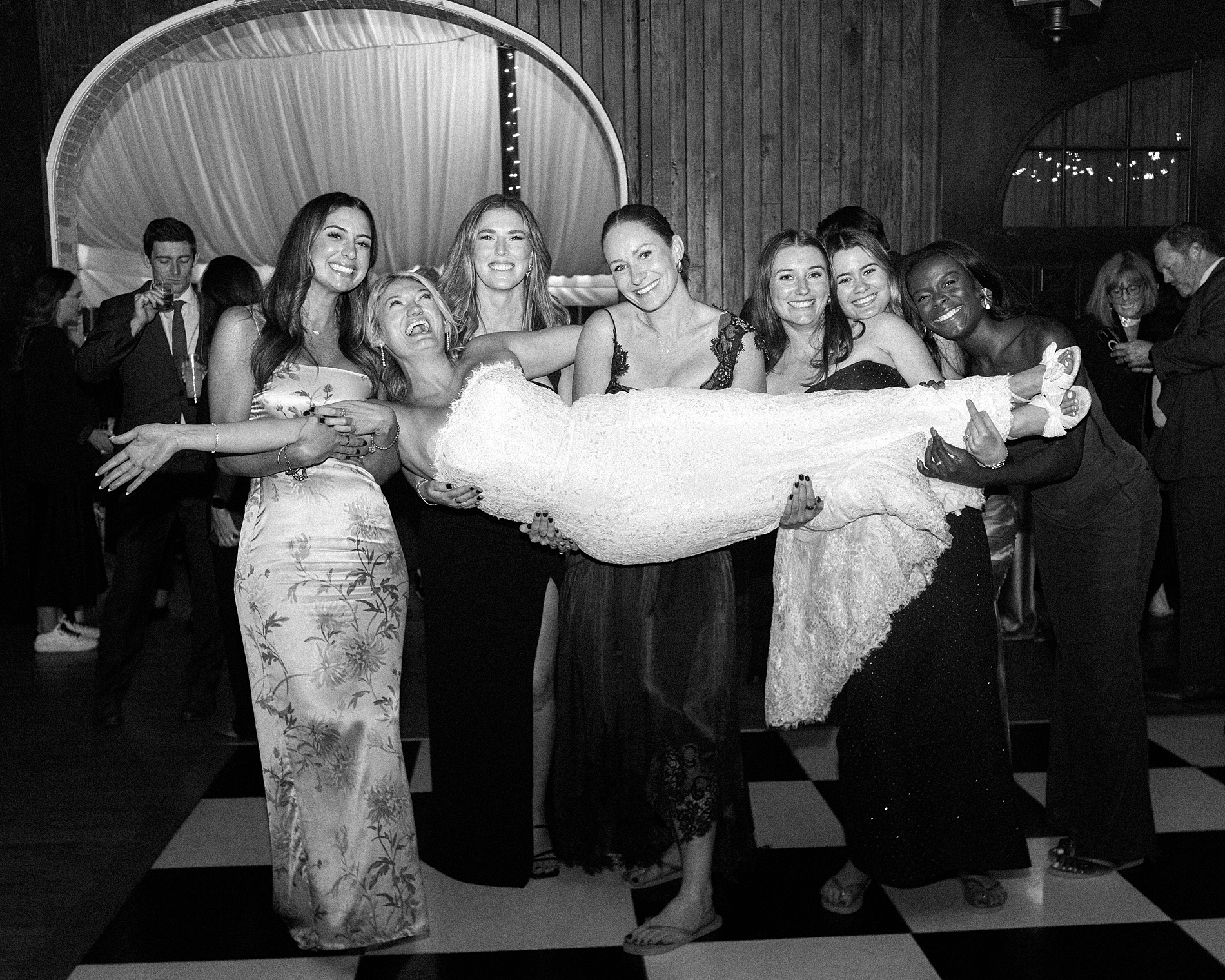 wedding guests lift bride up