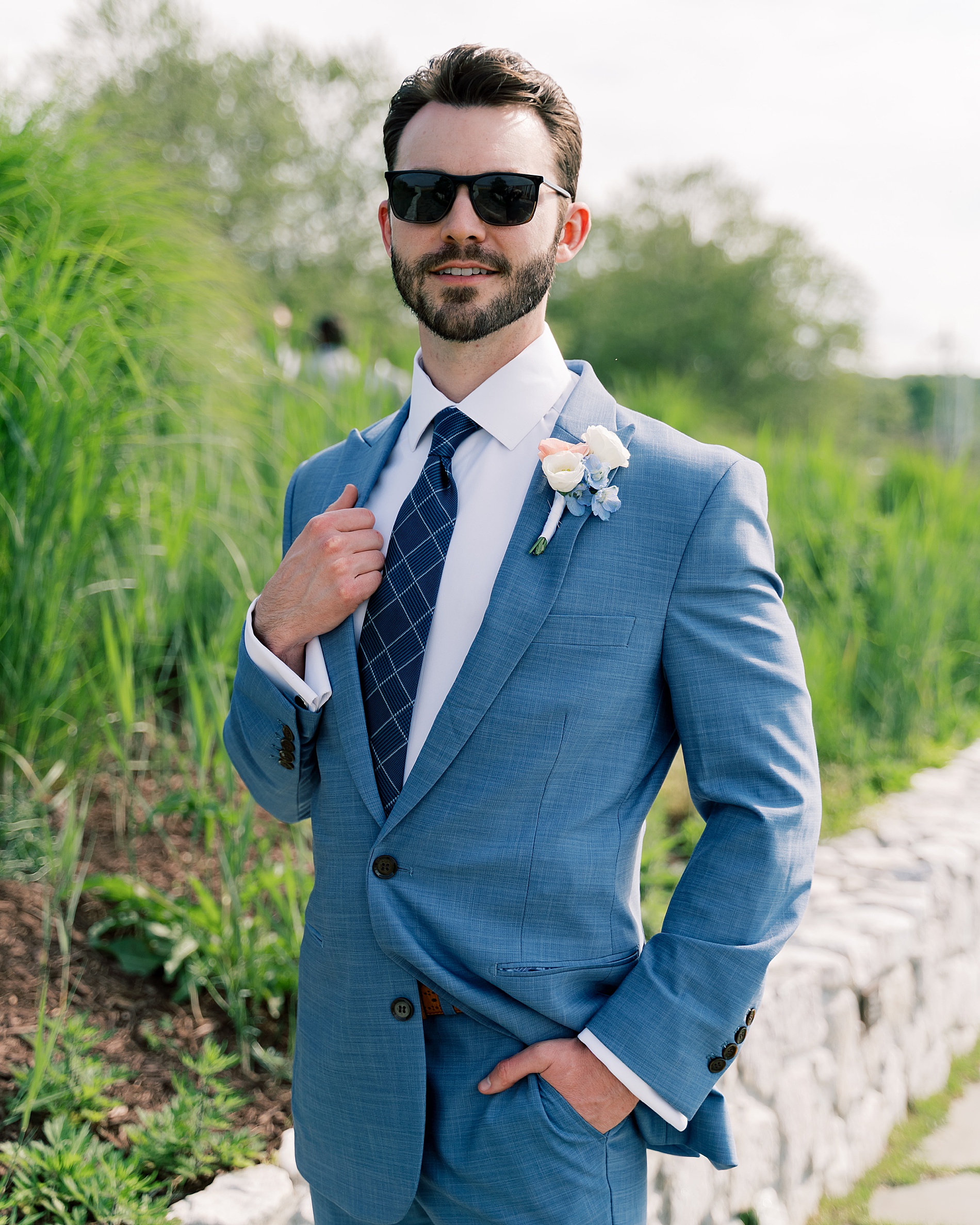 groom in blue suite wearing sunglasses 