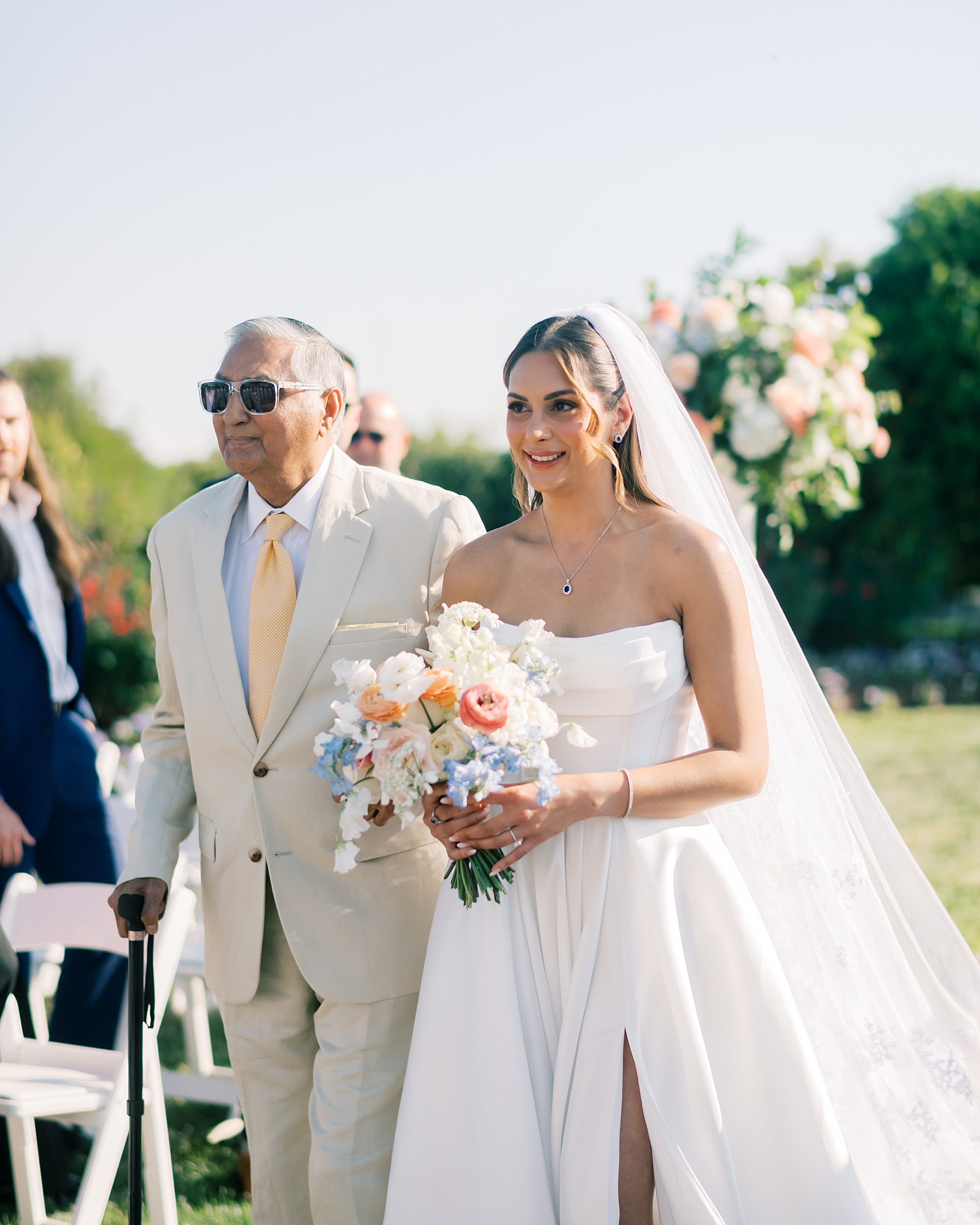 bride walks down the aisle with father 
