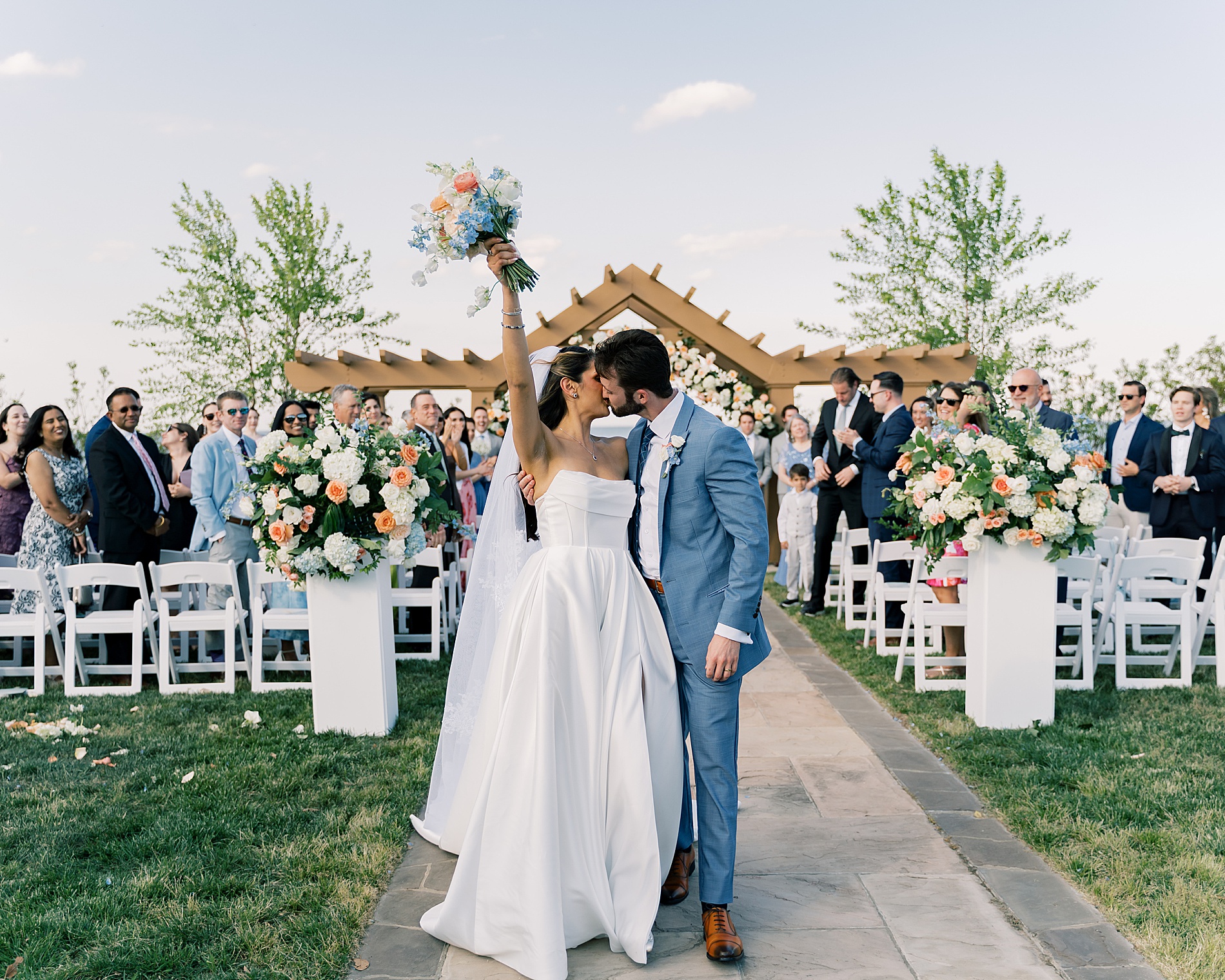 newlyweds kiss as they exit wedding 