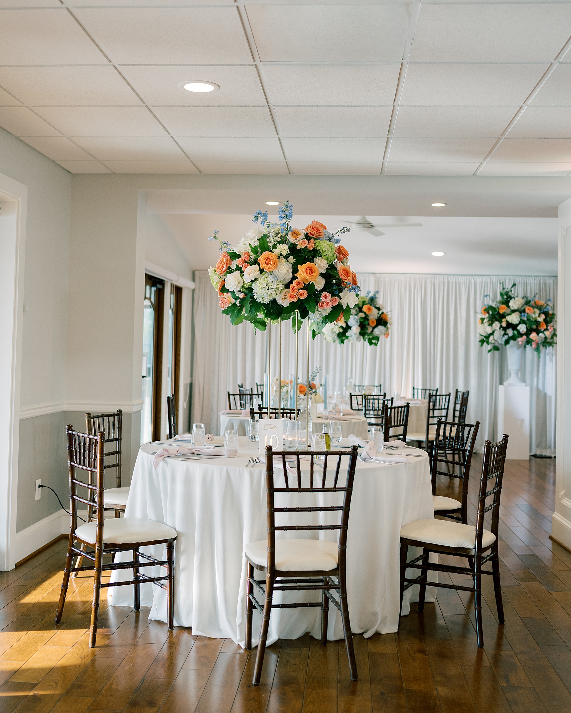 colorful summer flowers decorate tables at Herrington on the Bay wedding reception 
