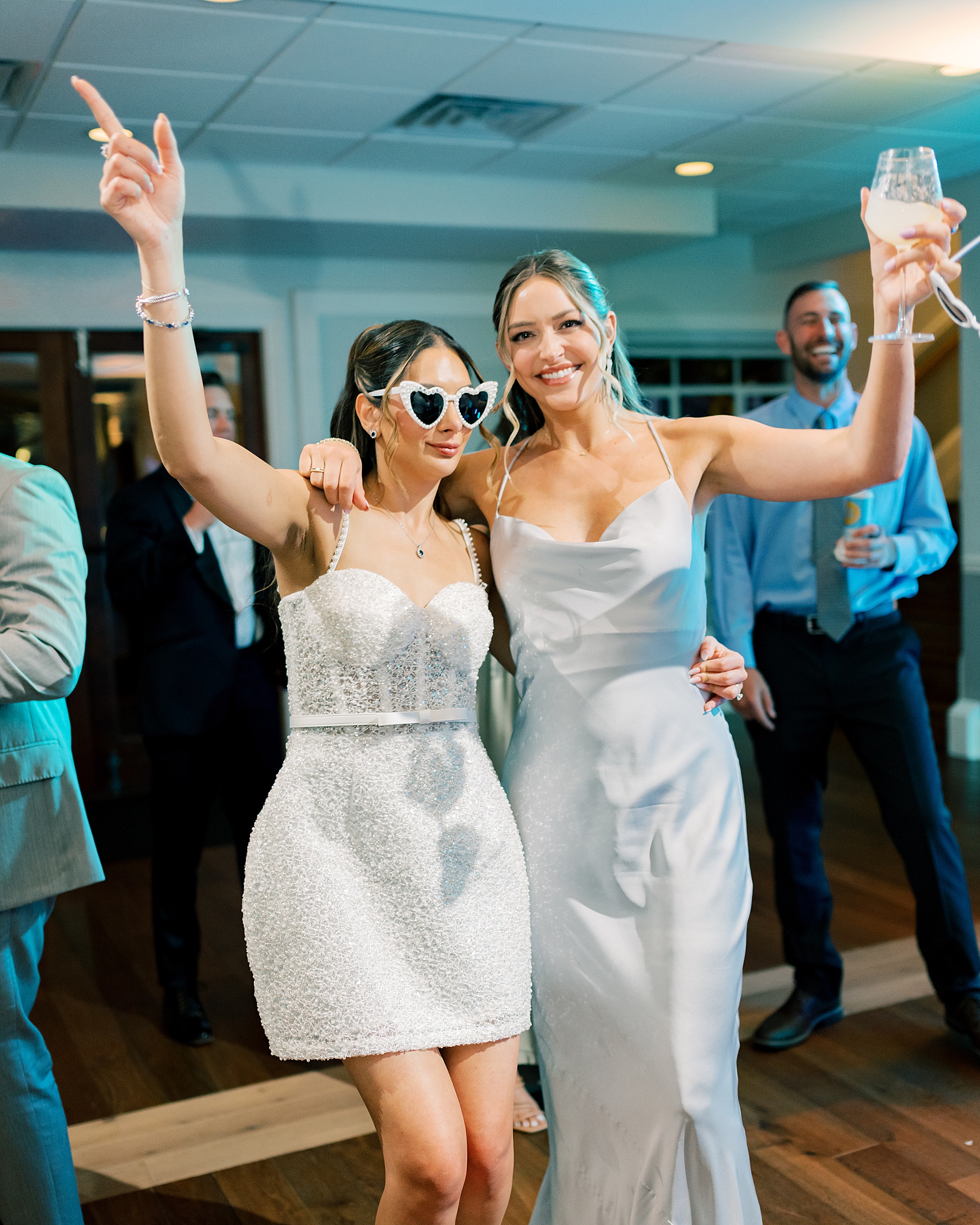 bride in reception dress with bridesmiad