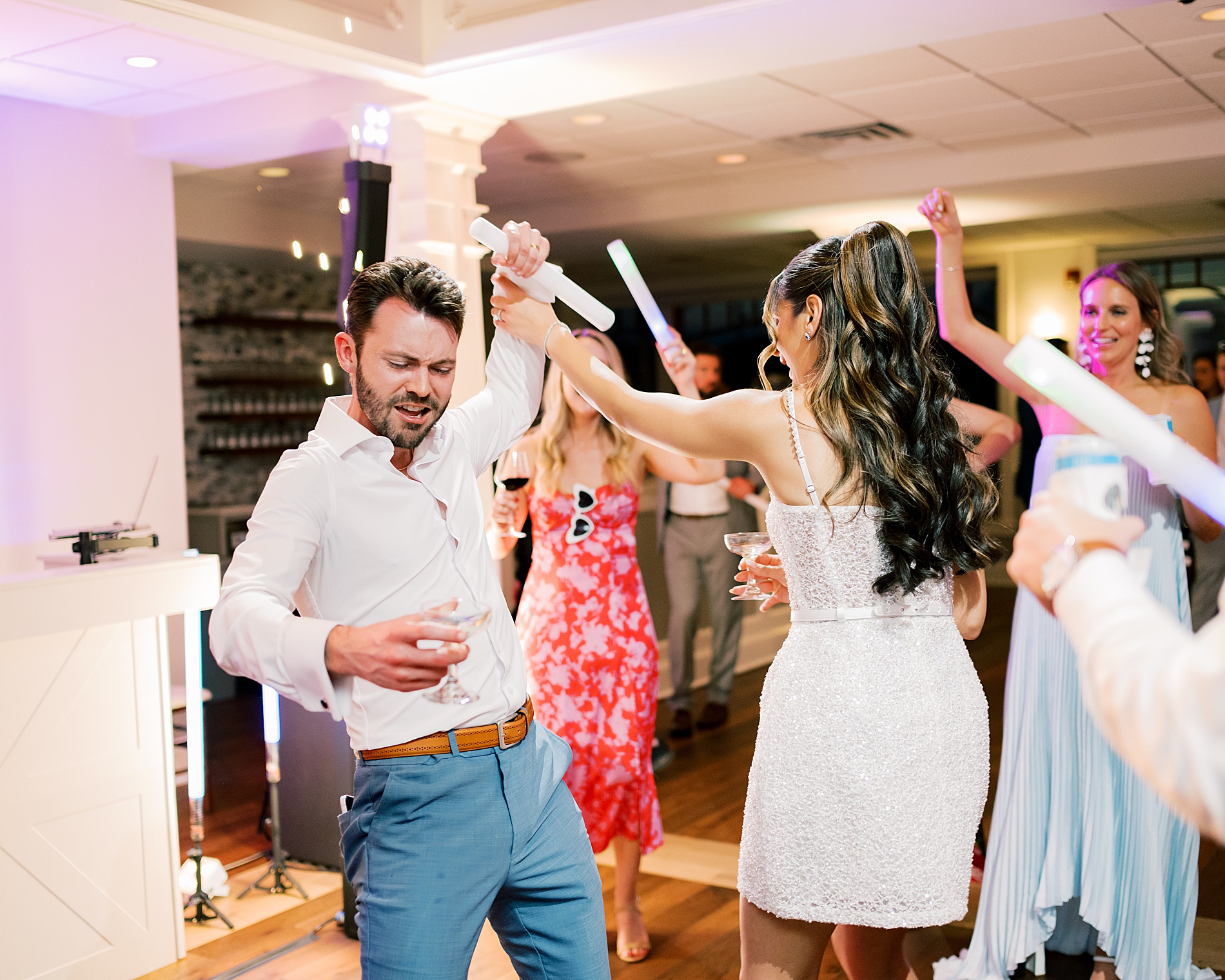 bride and groom on dance floor with guests 